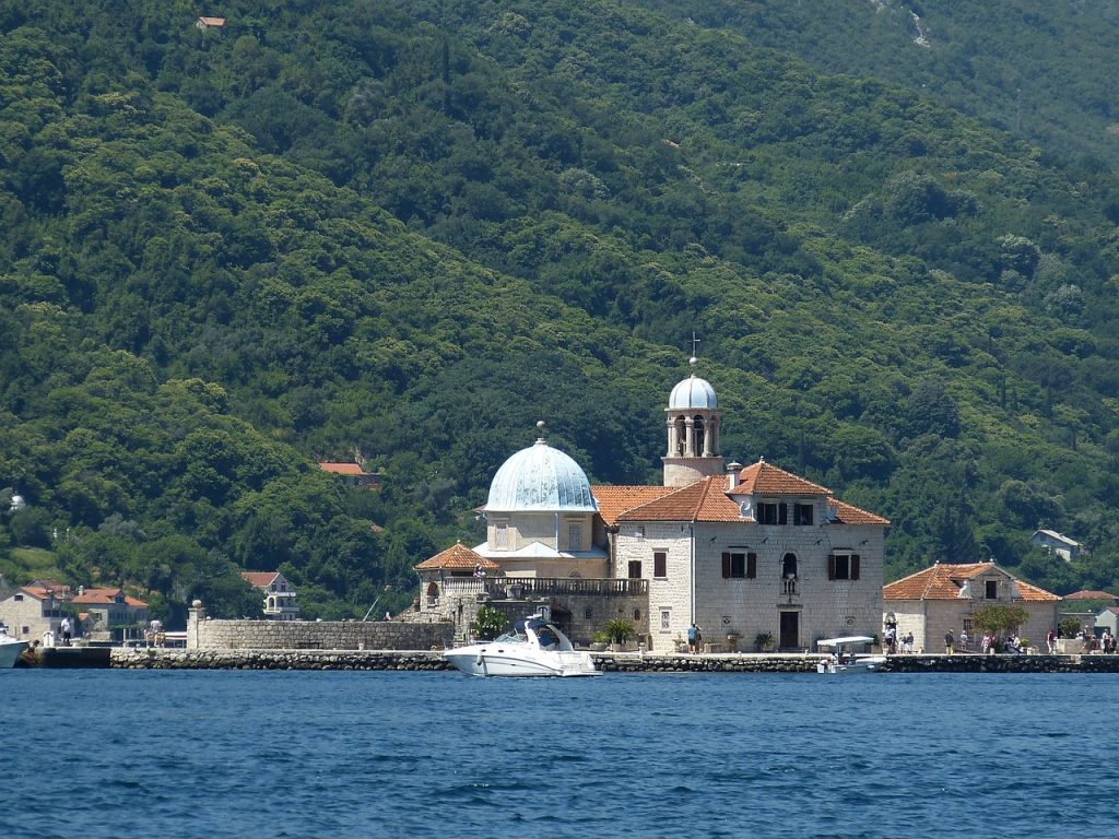 The photo shows the church of Our Lady of the Rocks.